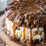 A homemade ice cream cake with caramel sauce dripping off the top.