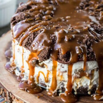 A homemade ice cream cake with caramel sauce dripping off the top.