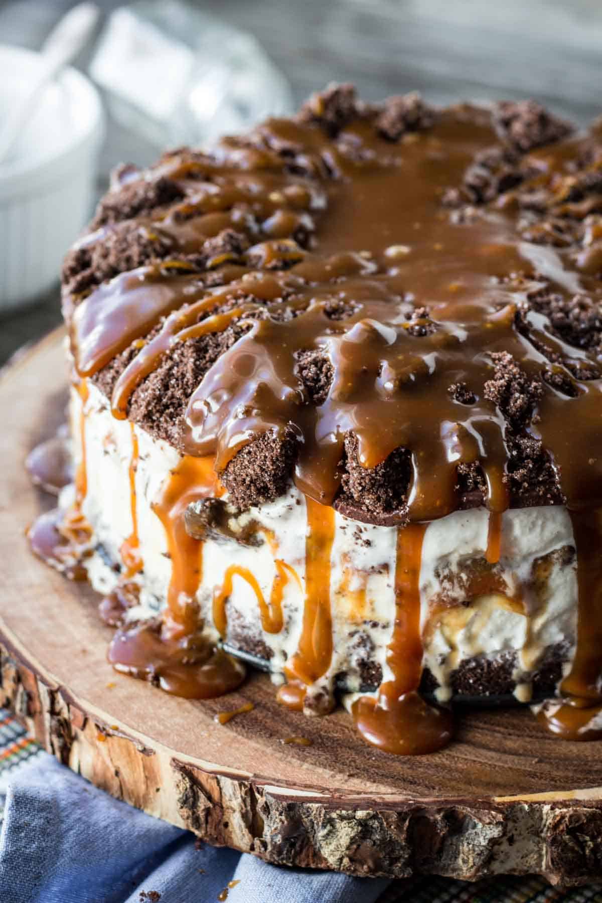 A homemade ice cream cake with caramel sauce dripping off the top.