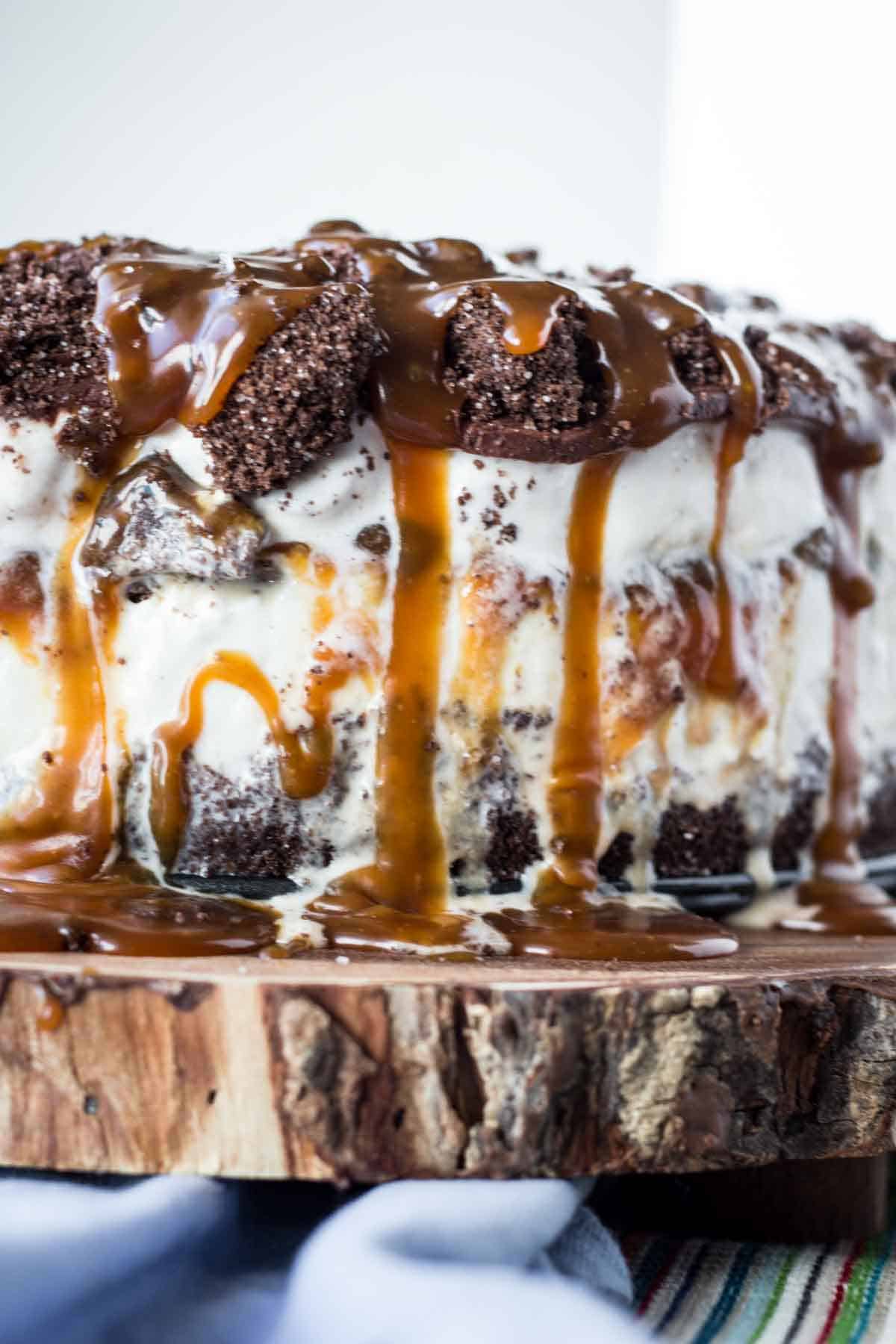 The side of a layered homemade ice cream cake with chocolate and caramel.