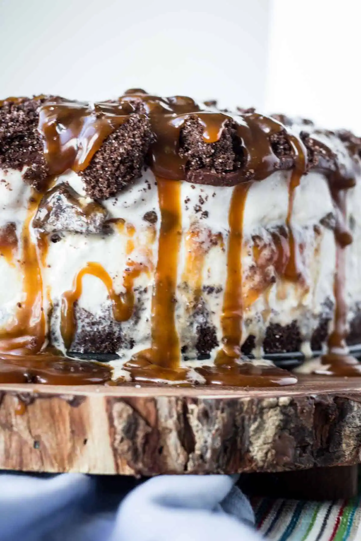The side of a layered homemade ice cream cake with chocolate and caramel.