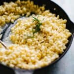 a cast iron pan filled with creamed corn.