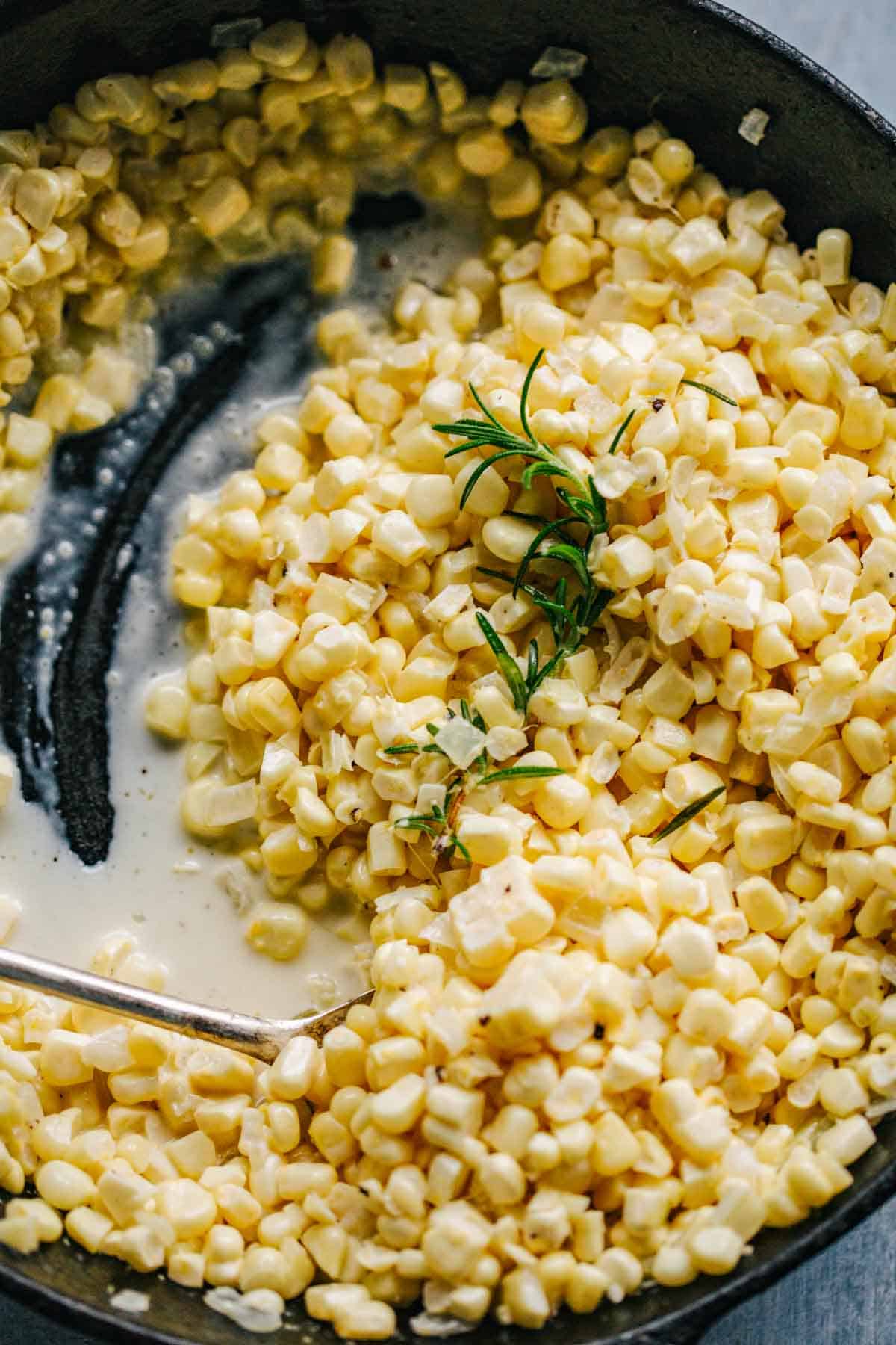 Close up of kernels of corn in a cream sauce.