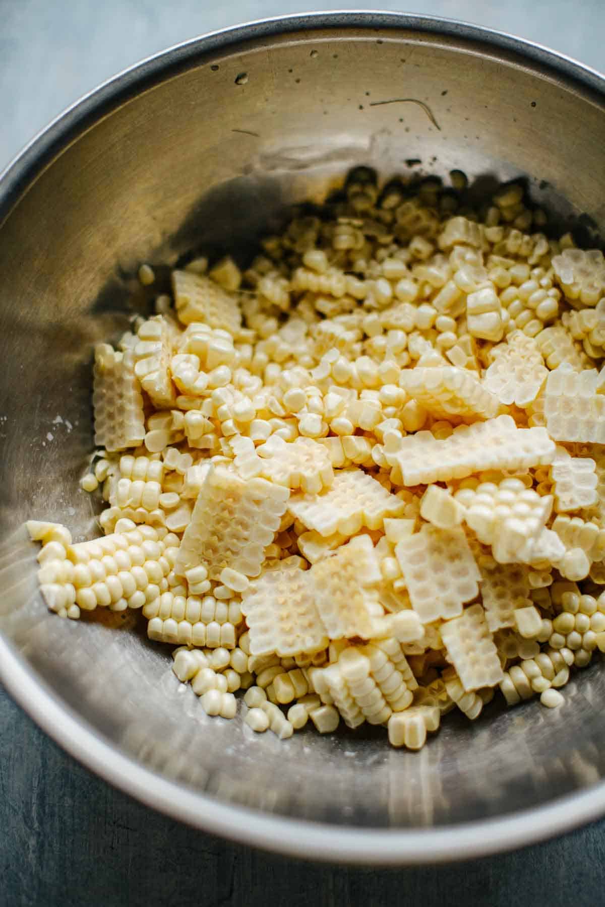 Pieces of corn cut off the cob in a large bowl.