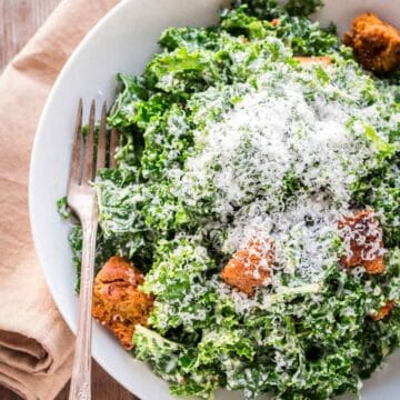 Caesar salad with lots of grated cheese on top.
