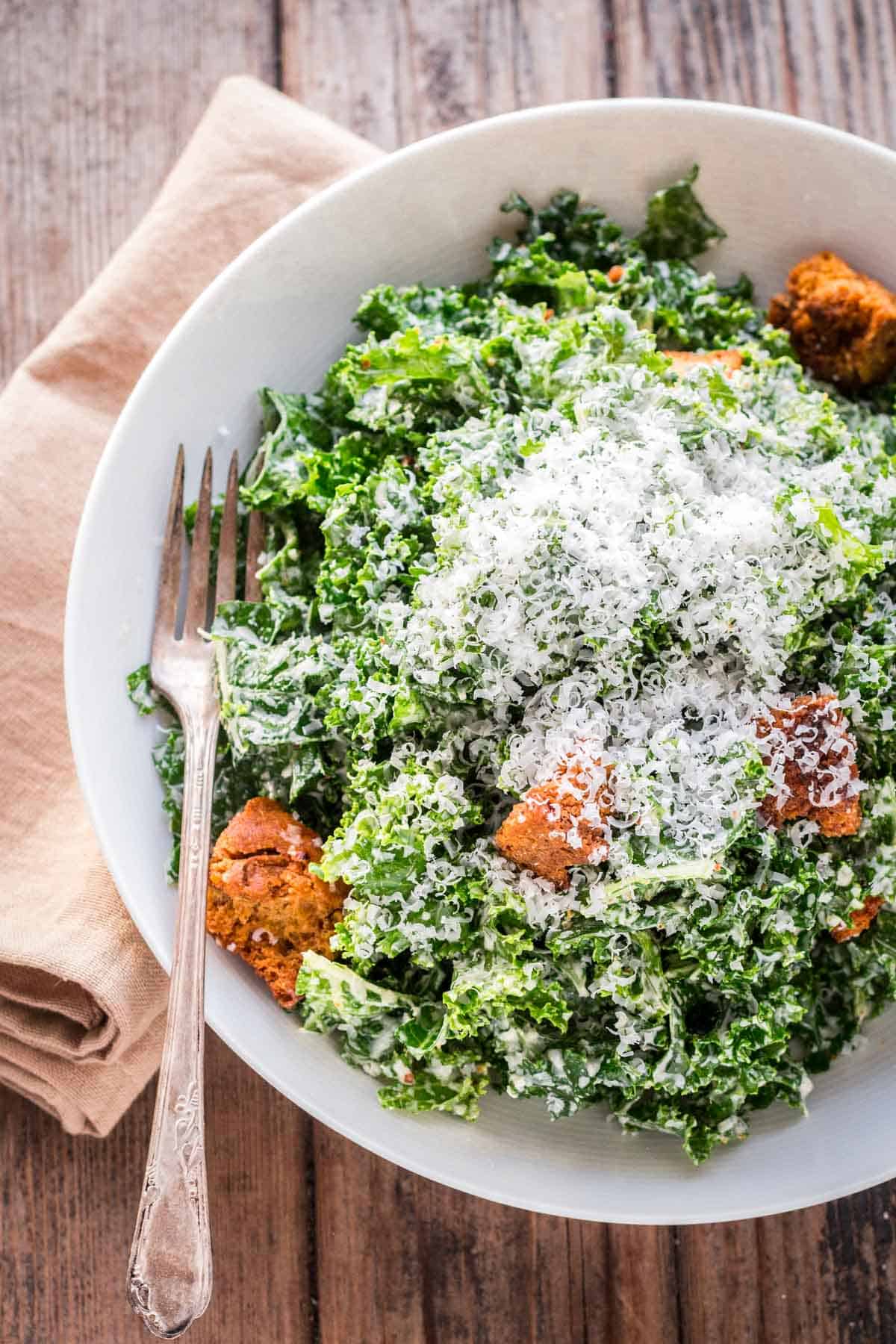 Caesar salad with lots of grated cheese on top.