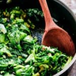 A pan and wooden spoon with Italian style sautéed escarole.
