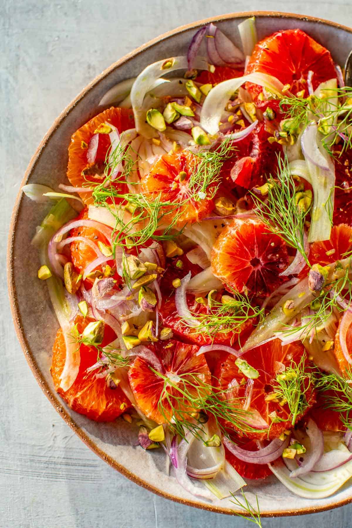 A plate of blood oranges and shaved fennel with pistachios. 