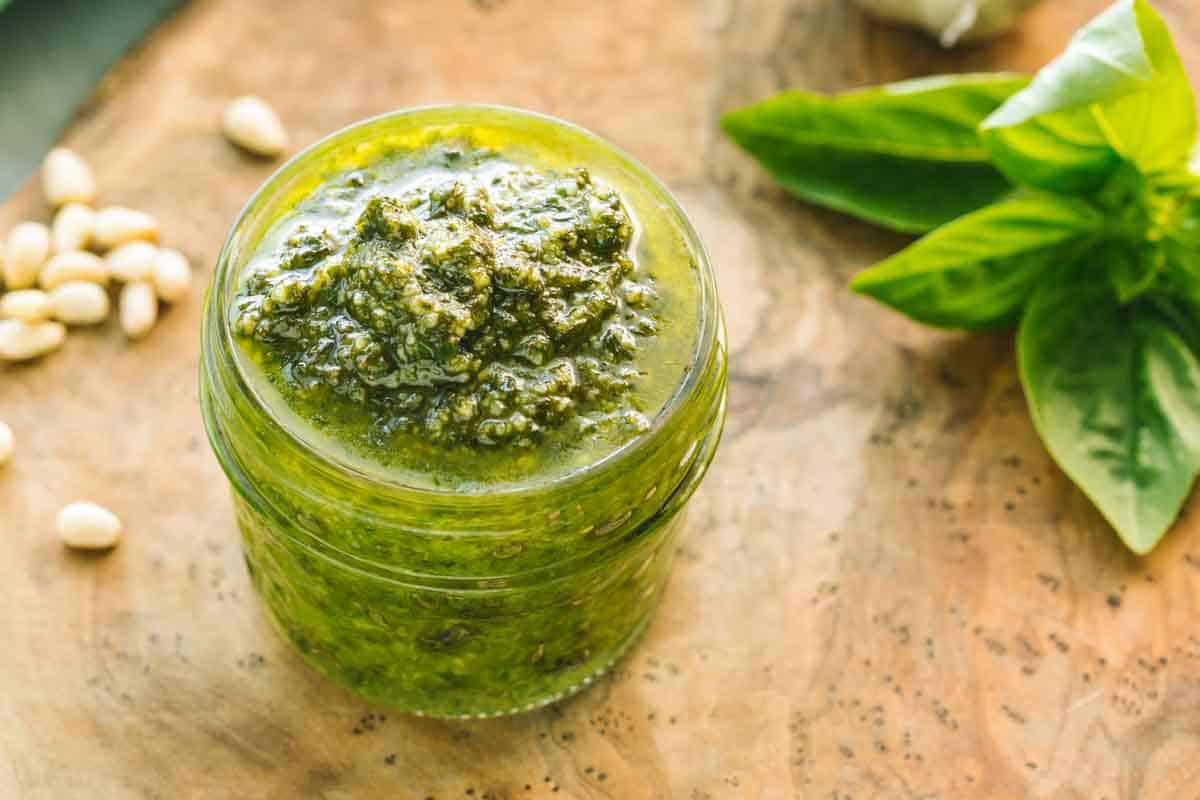 A small mason jar filled with pesto.