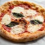 A Margherita pizza with fresh mozzarella and basil.