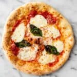 Neapolitan style pizza with fresh mozzarella, tomato sauce, and basil.