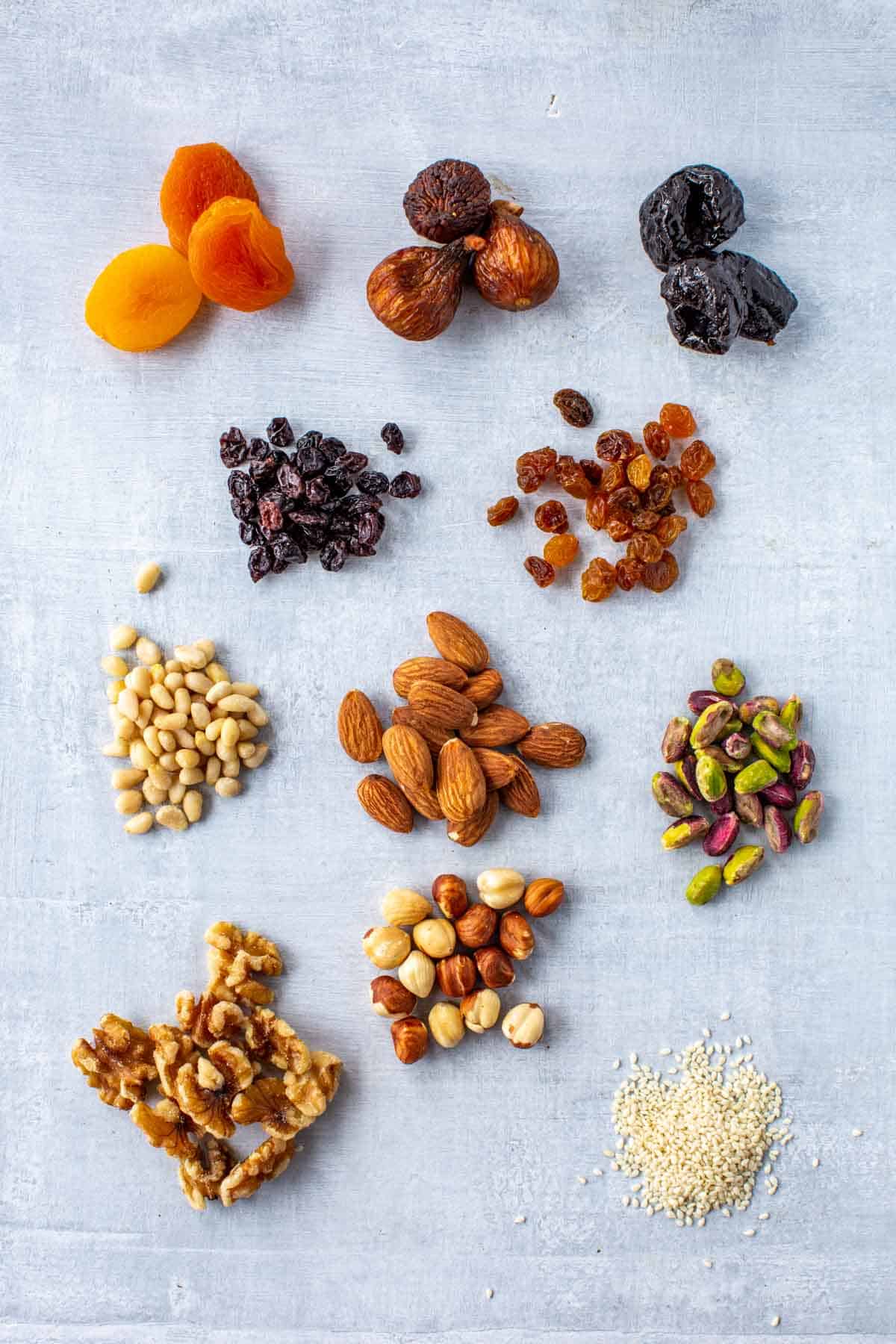 Small piles of assorted dried fruits and nuts used in Italian cooking and baking.