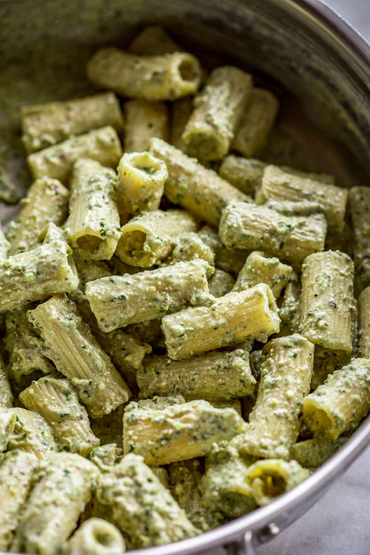 Creamy ricotta pesto pasta in a pan.