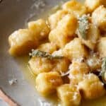 Gnocchi in a sage brown butter sauce with grated parmesan on top.