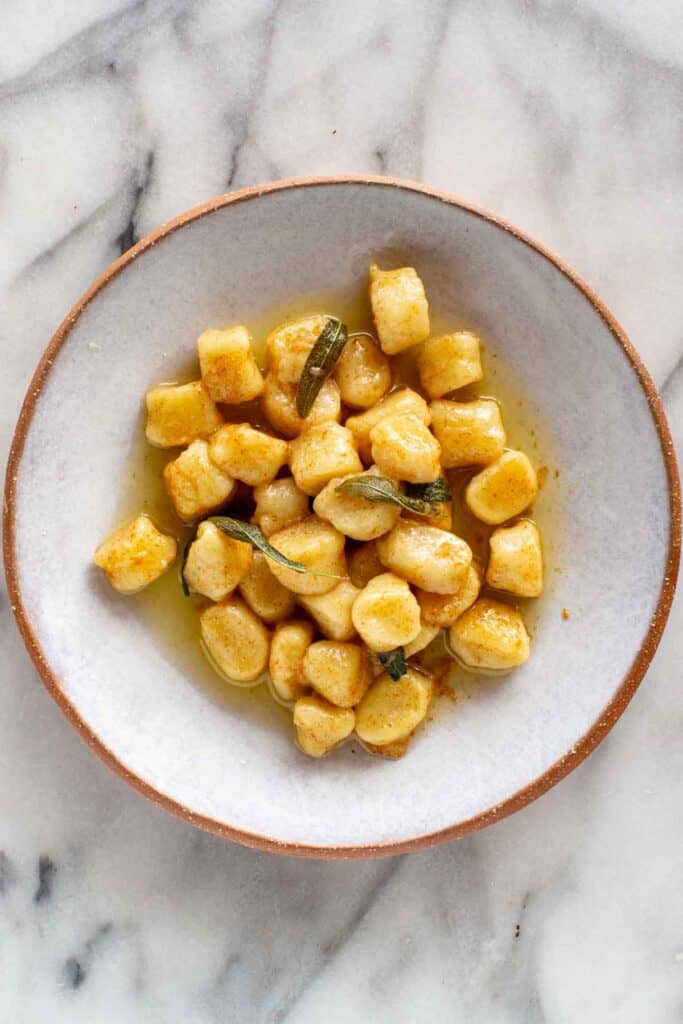 A plate of brown butter sage potato gnocchi.