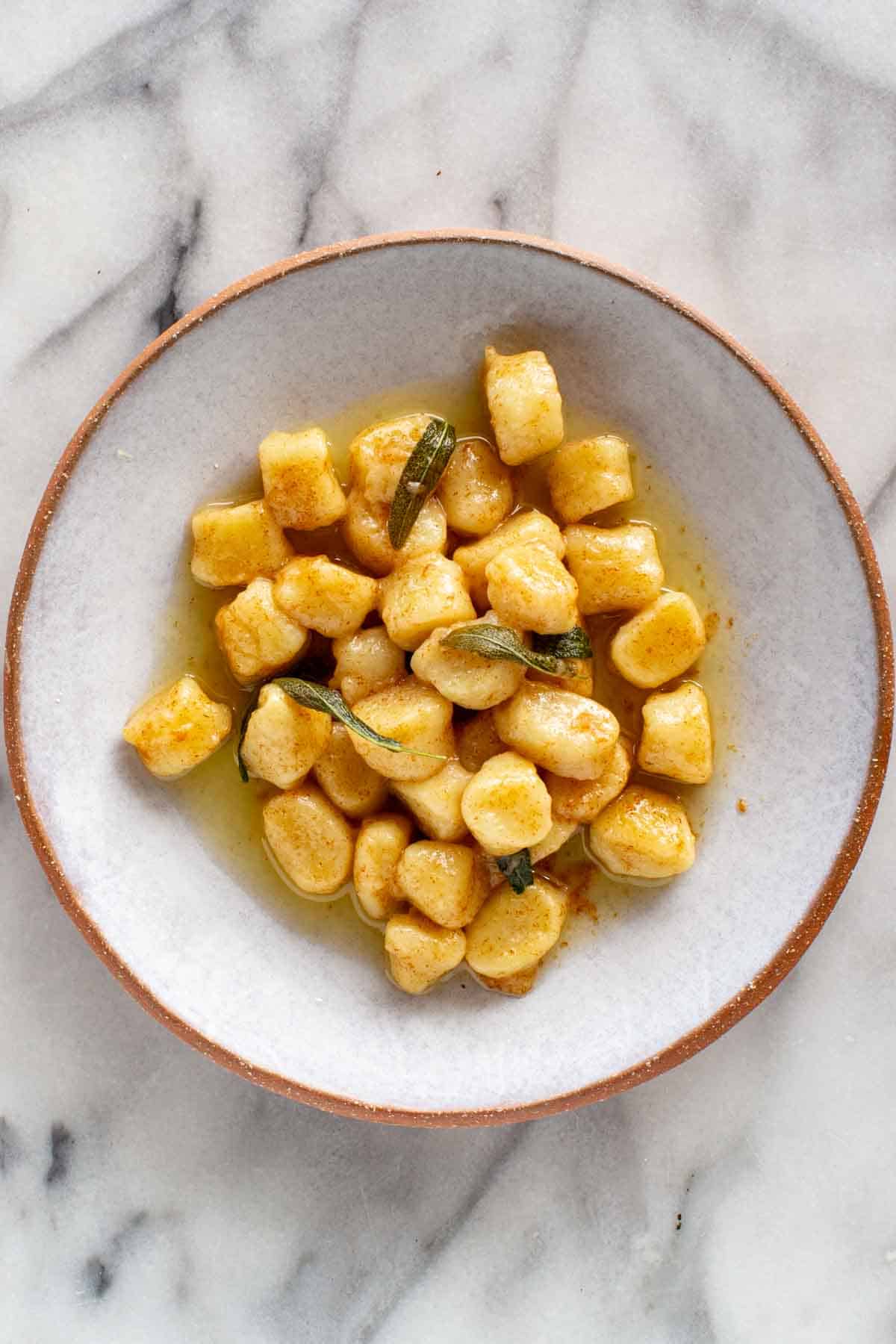 A plate of brown butter sage potato gnocchi.