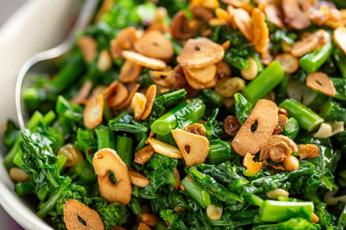 Sautéed rapini Siiclian style with pine nuts and raisins.
