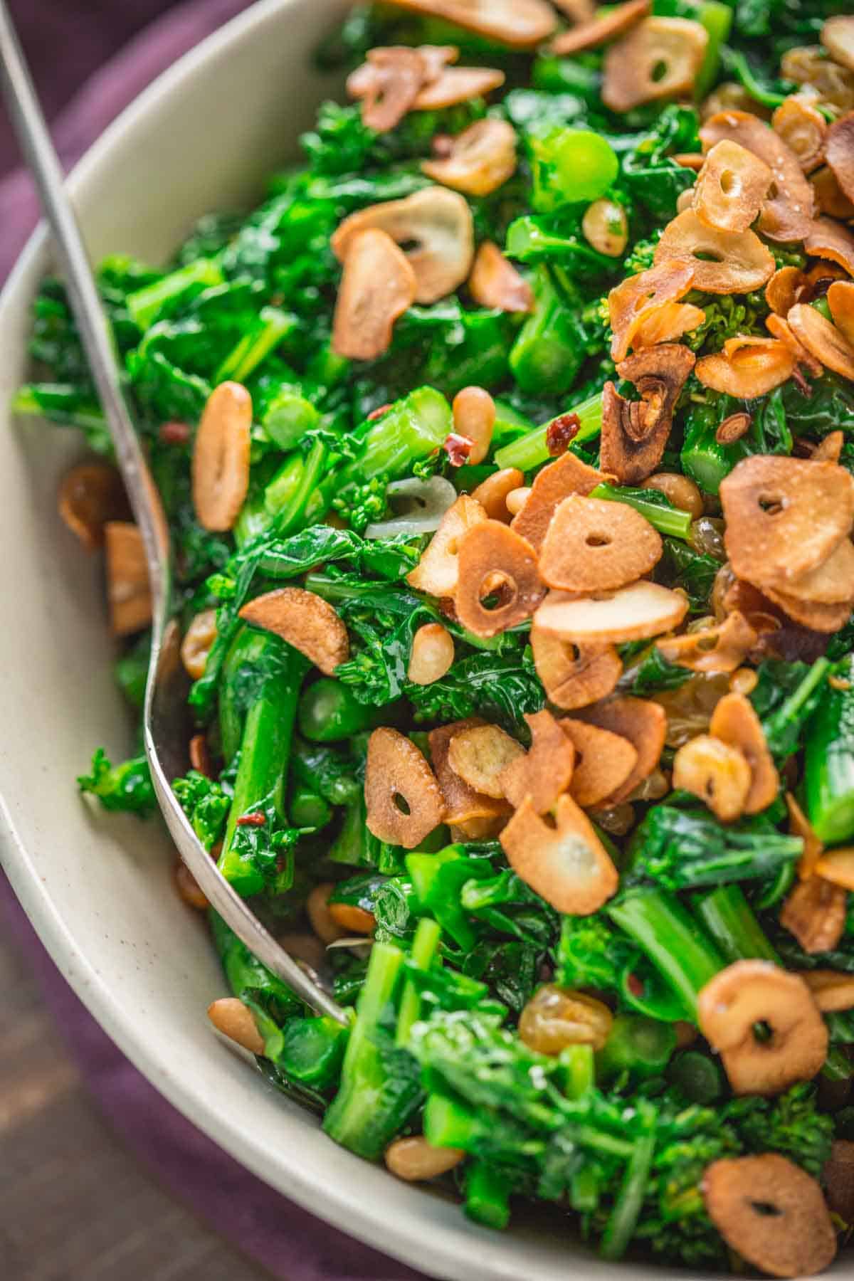 Sautéed broccoli raab with crispy garlic chips on top.