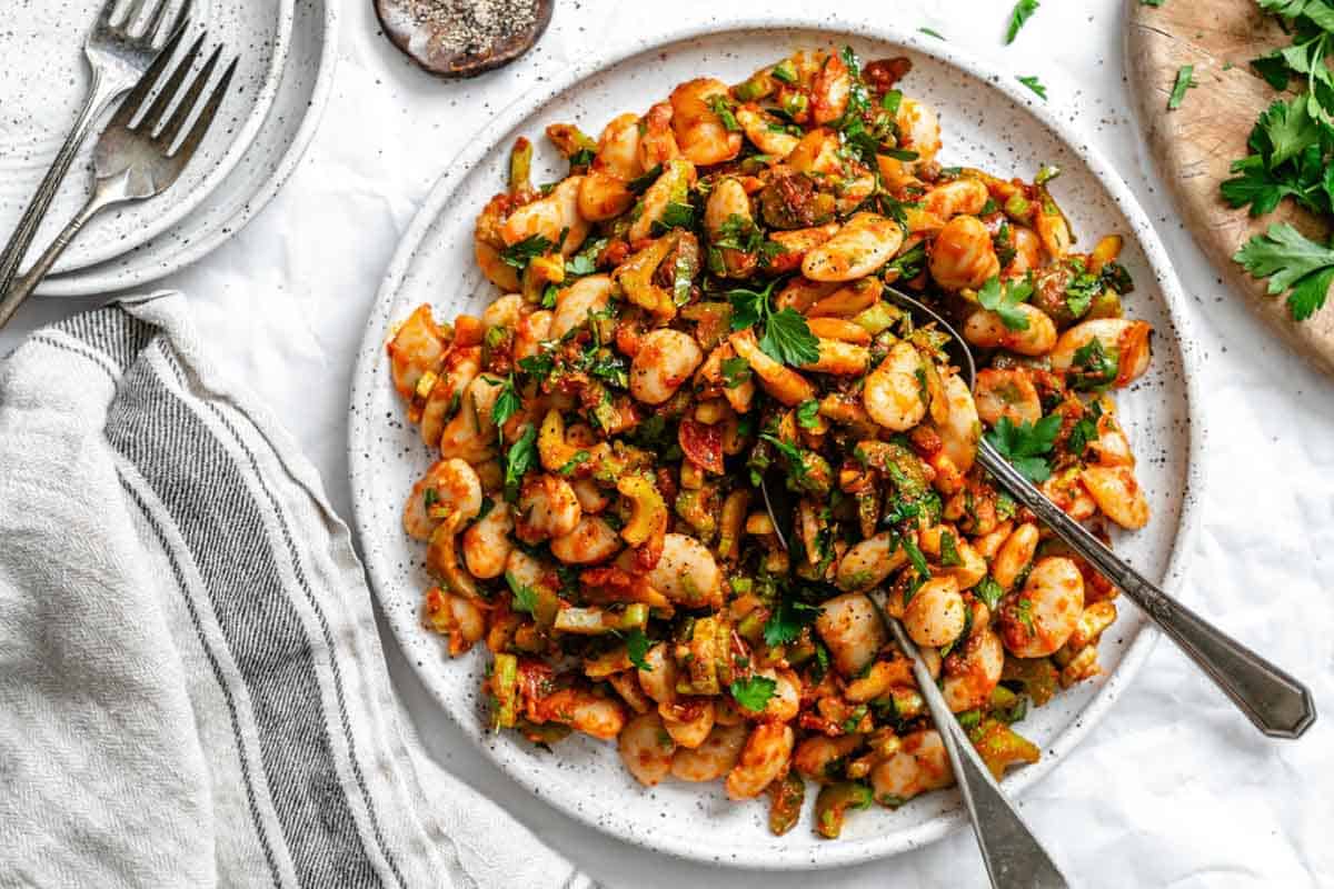 A plate of gigante bean salad with smoked paprika, celery and parsley.