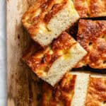 Side view of stacked focaccia bread pieces showing the airy texture and golden crust.