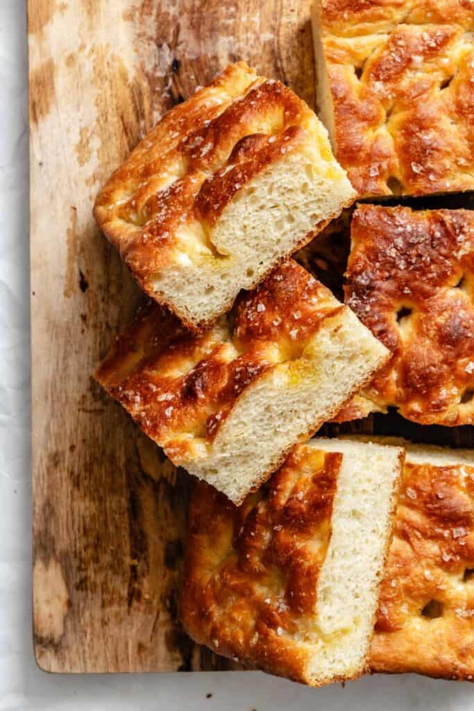 Side view of stacked focaccia bread pieces showing the airy texture and golden crust.