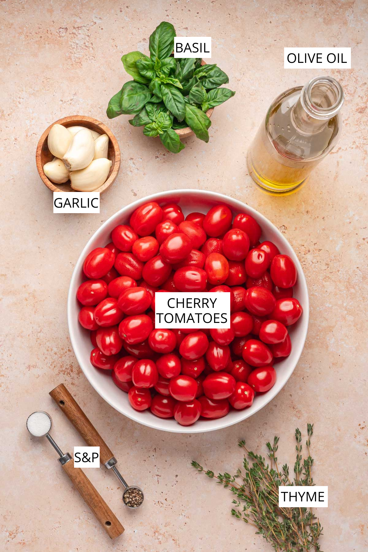 Flat lay of ingredients: cherry tomatoes, garlic, basil, thyme, olive oil, salt, and pepper.