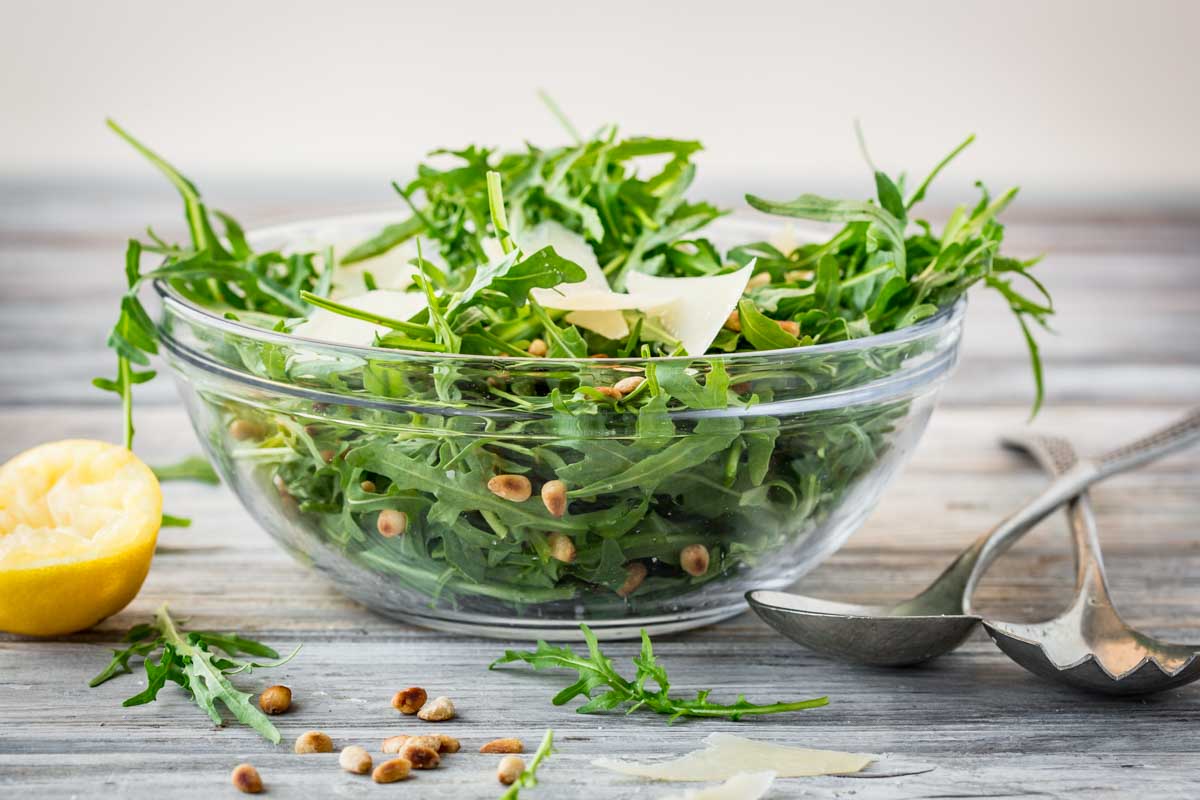 Fresh plated arugula dish similar to sautéed version