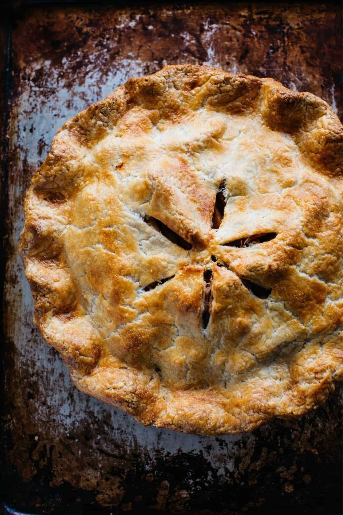 Freshly baked old fashioned apple pie on a sheet pan.