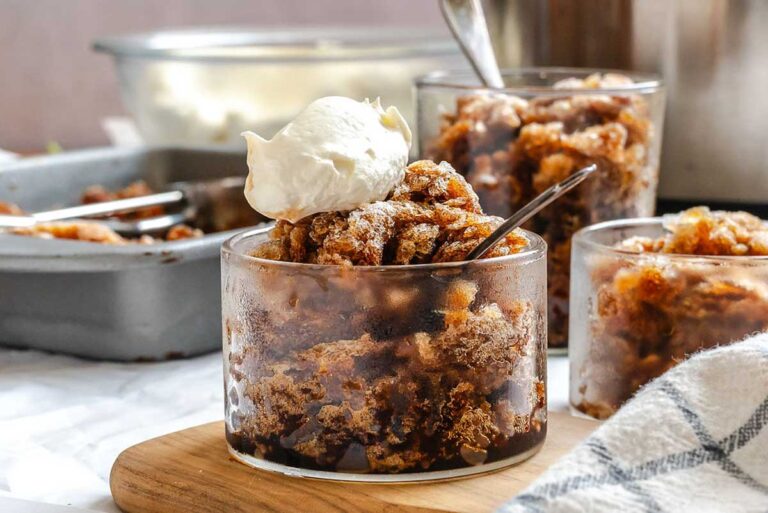 Several glasses of Sicilian coffee granita with whipped cream, with the pan in the background.