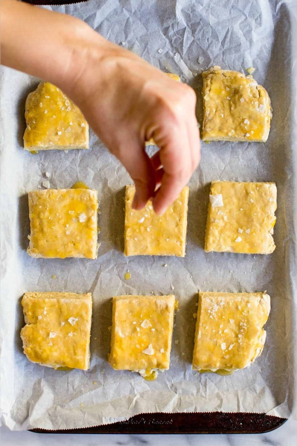 sprinkling salt on biscuits before baking Irish cheddar and stout biscuits.