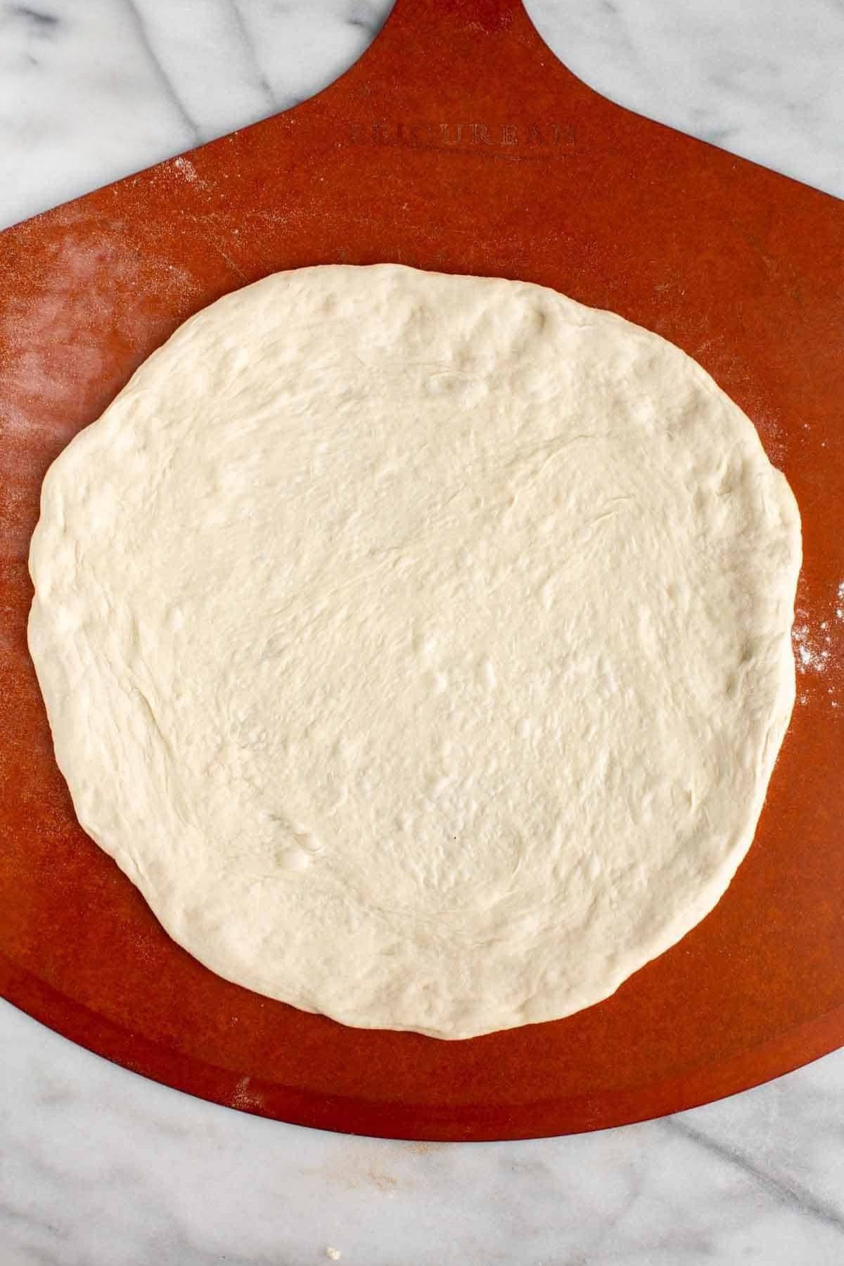 Rolled out pizza dough ready for toppings.