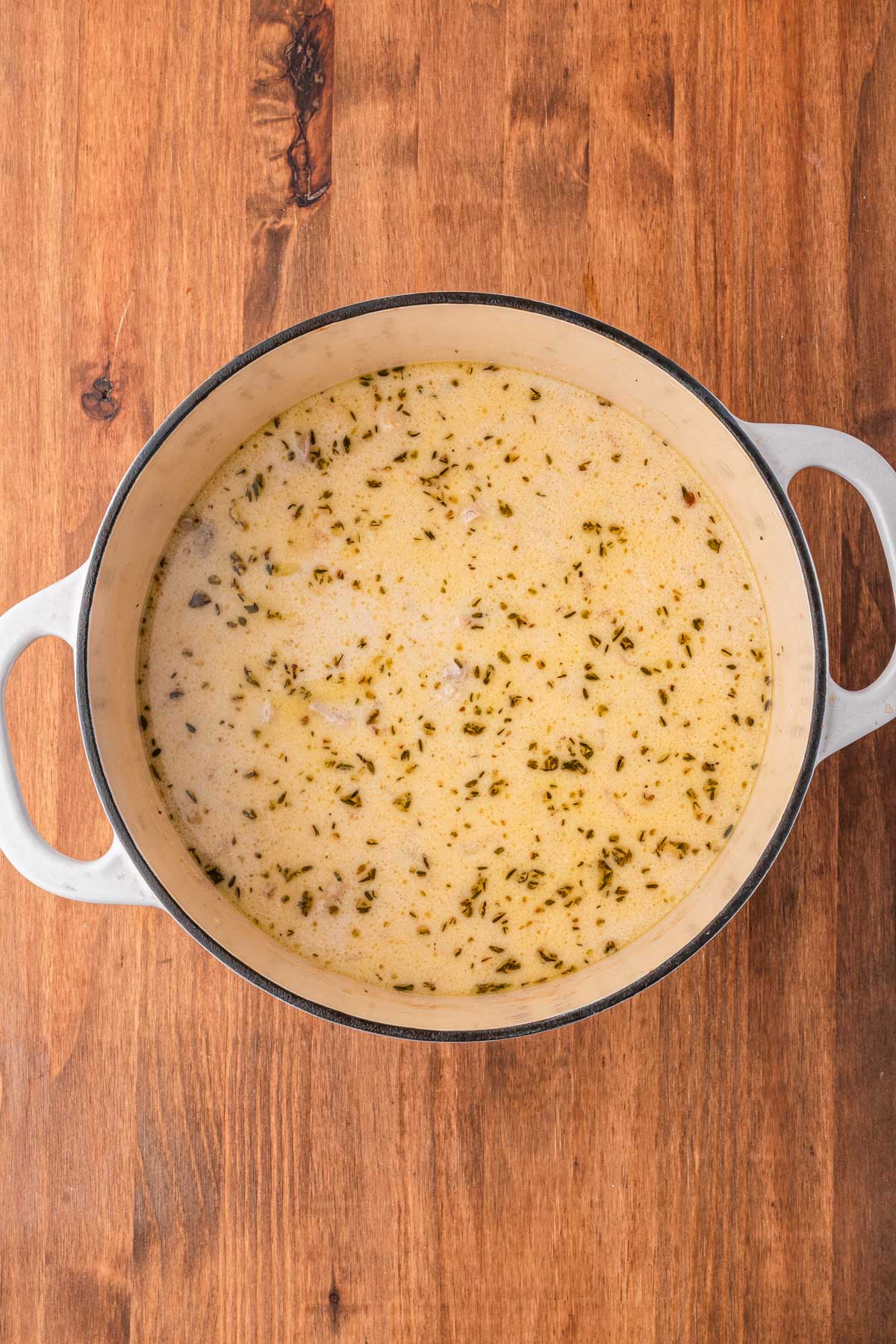 Cream stirred into simmering broth and chicken, giving the soup a rich creamy texture.