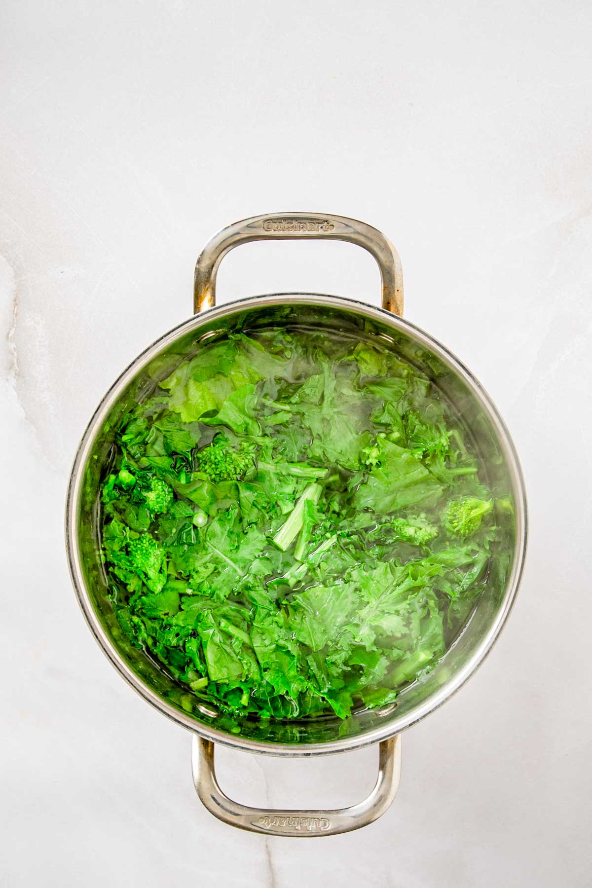 Bright green broccoli rabe blanched in a large pot of salted water until just tender.