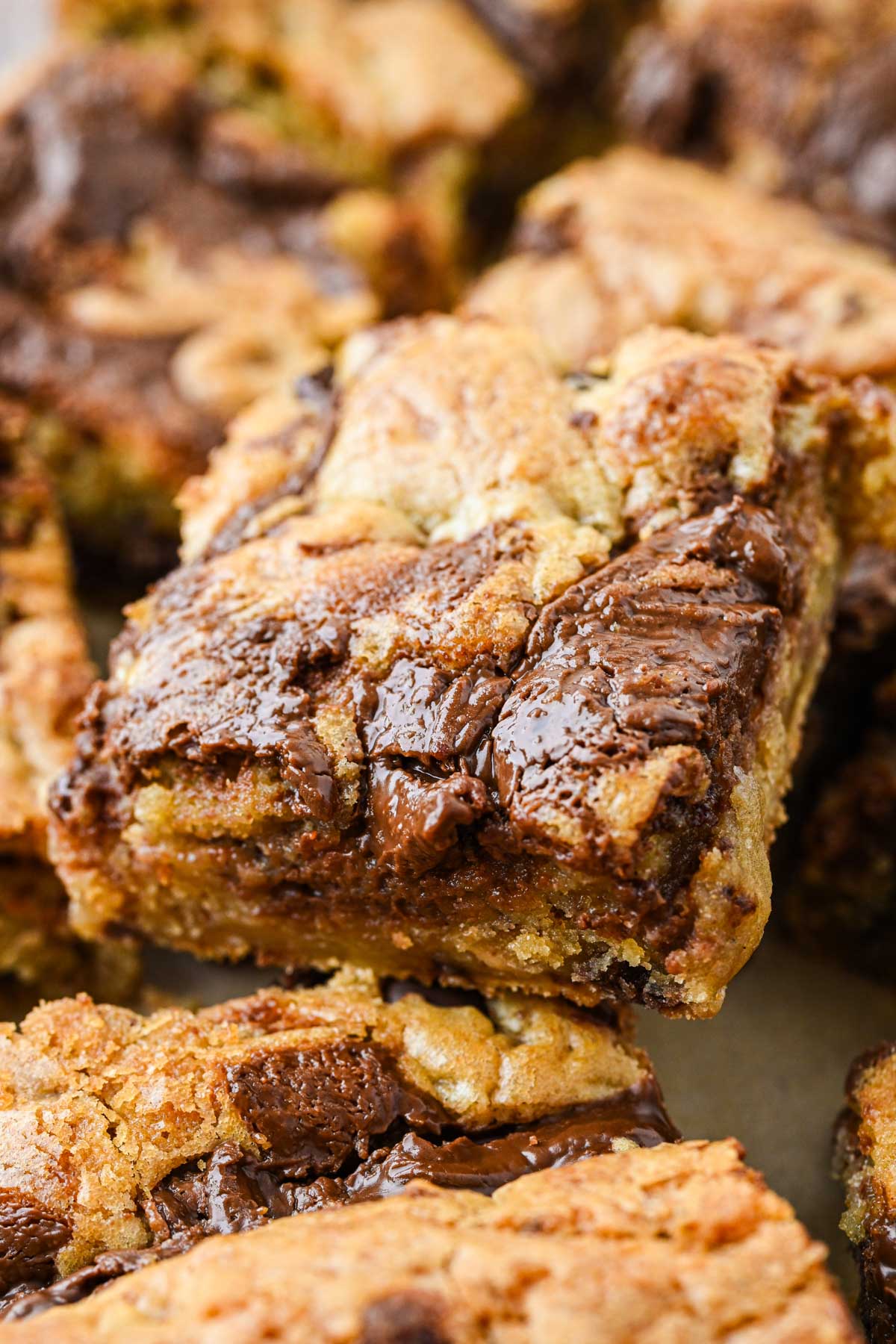 Macro shot of a blondie square showing melted Nutella, crisp edges and a soft, gooey center.