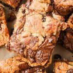 Overhead shot of multiple blondie squares highlighting their marbled Nutella tops and golden edges.