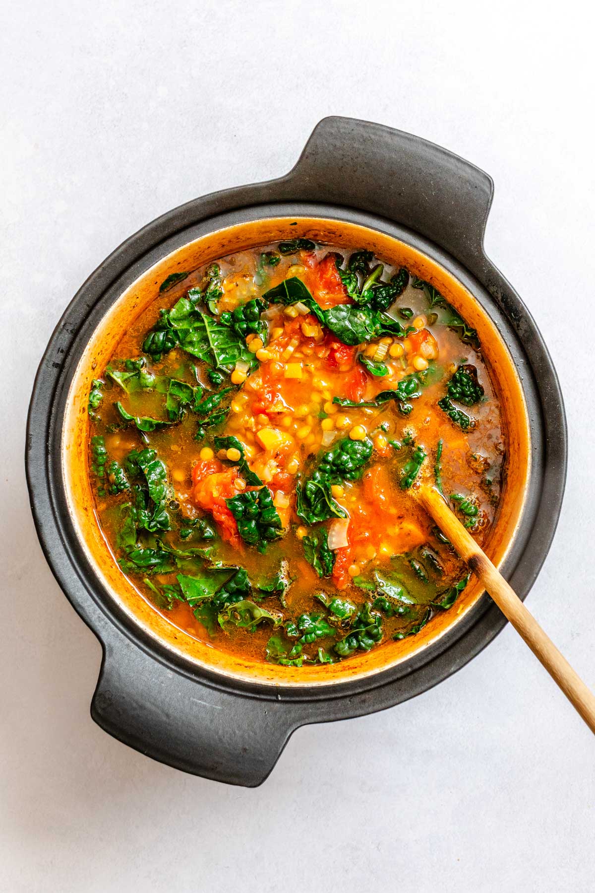Tuscan kale stirred into the simmering lentil soup as it cooks down and softens.