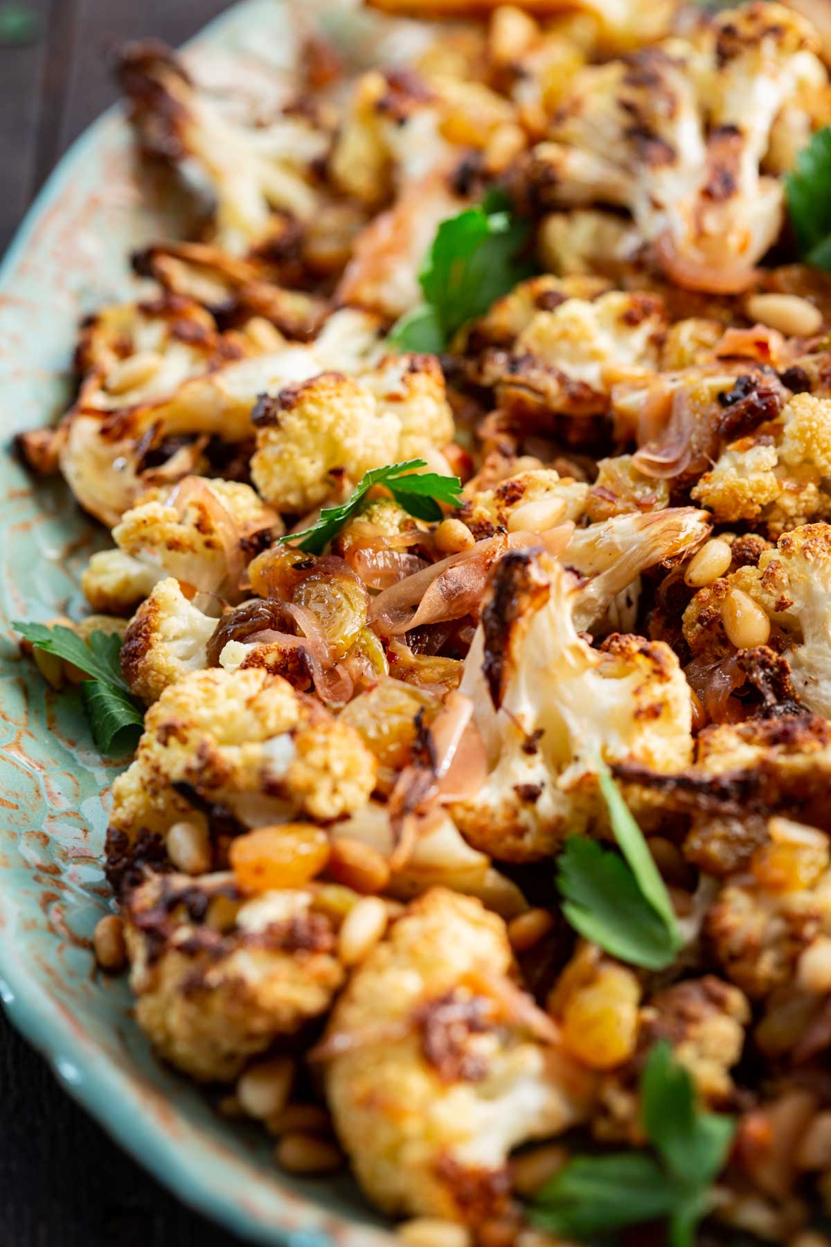 Tight detail of cauliflower agrodolce highlighting the glossy sweet and sour sauce clinging to the florets.