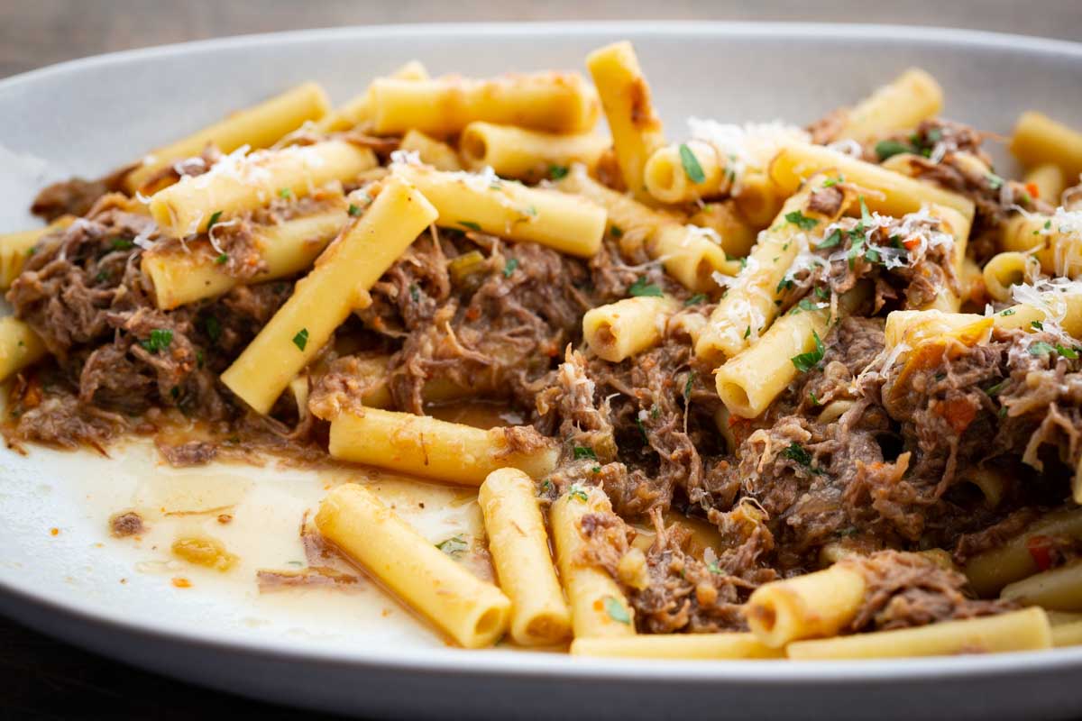 Side close up of serving plate filled with pasta alla genovese.