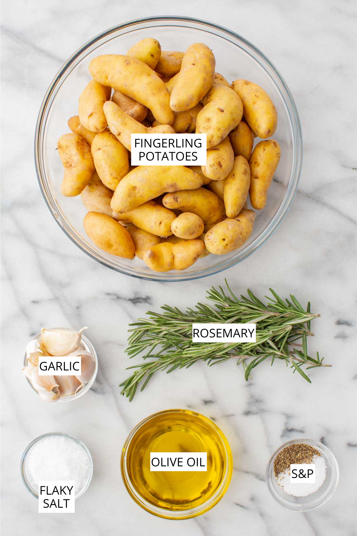 Labeled ingredients of roasted fingerling potatoes including potatoes, garlic, olive oil and rosemary.