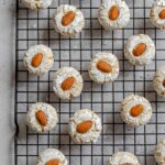 Overhead shot of Italian almond cookies over a cookie tray in a gray marble background.