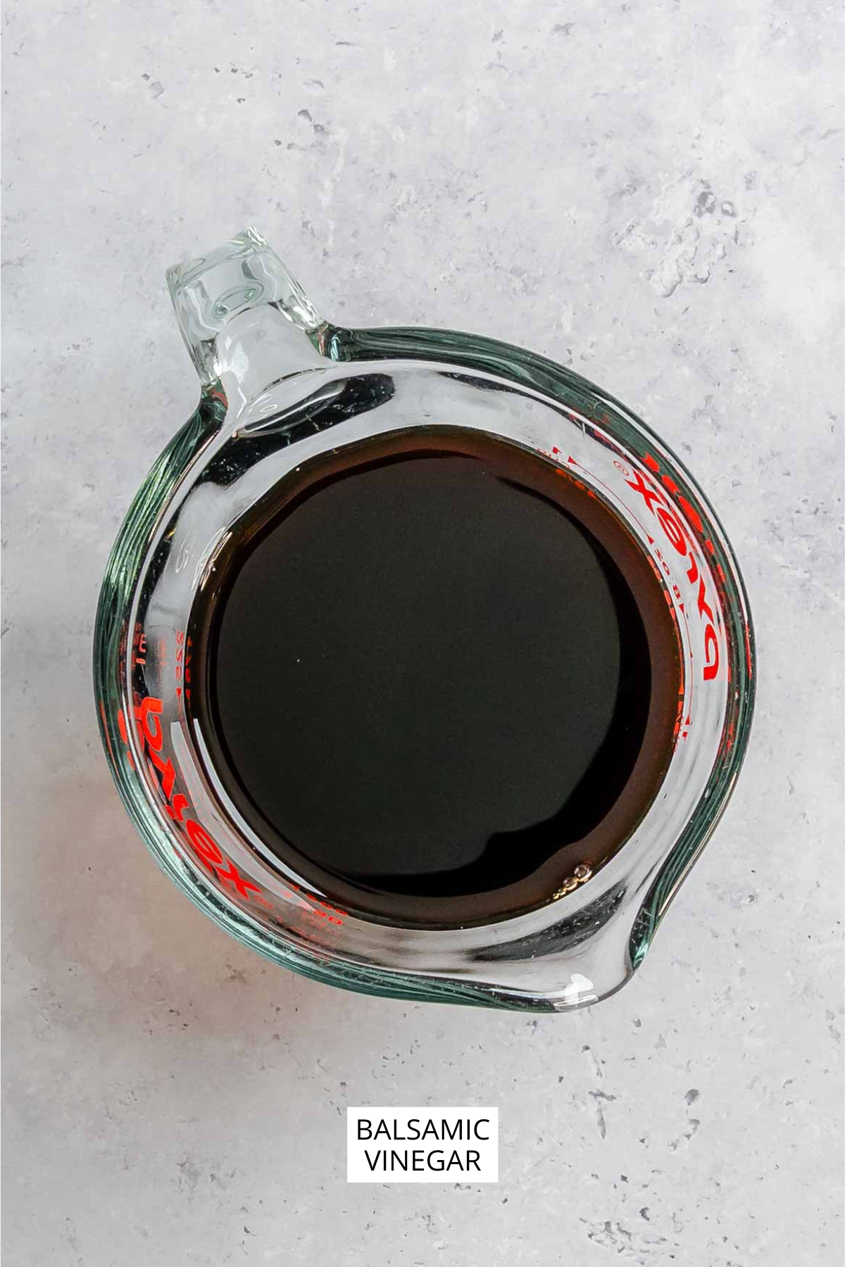 Balsamic vinegar on a measuring cup.
