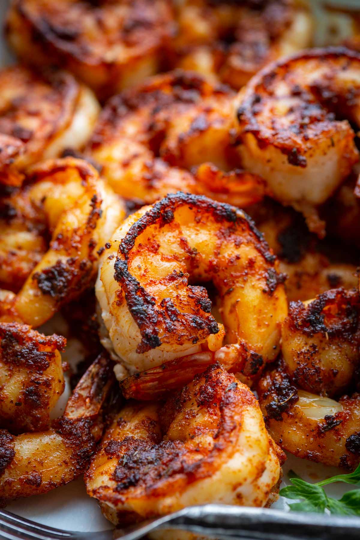 Side view of blackened shrimp with a dark spice crust.