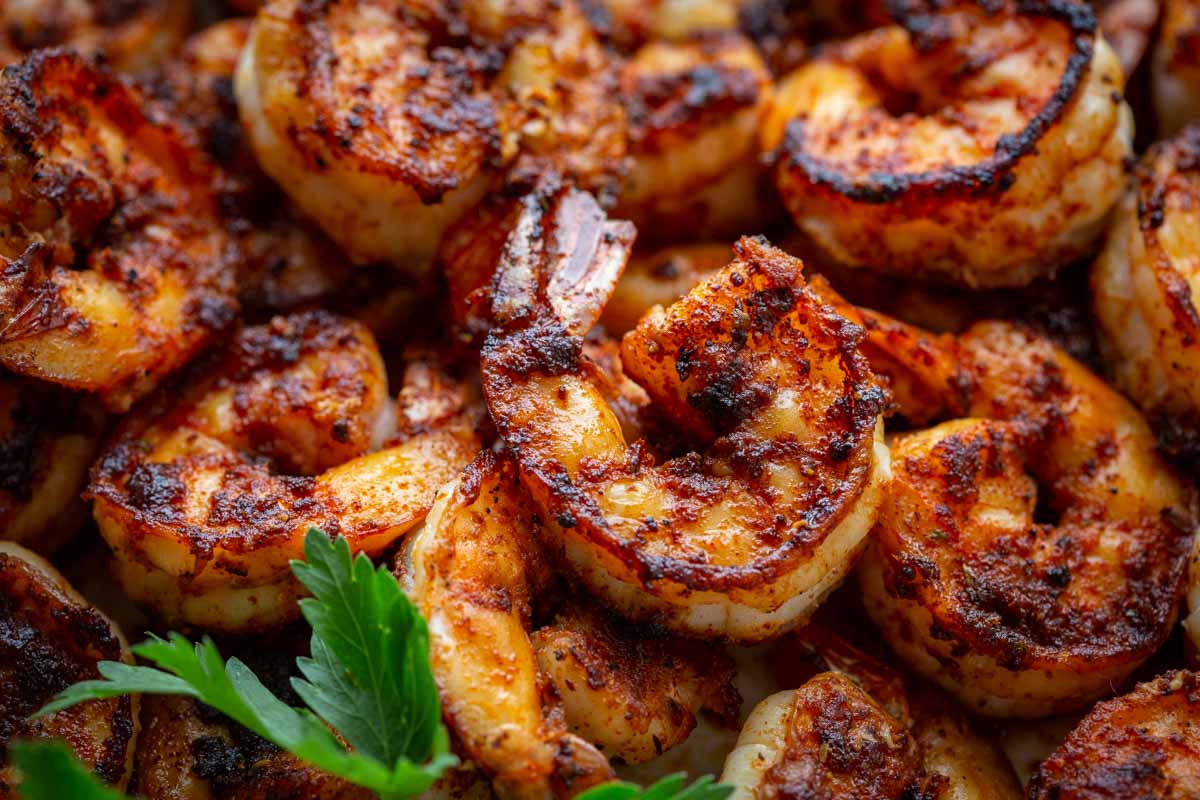 Close up of blackened shrimp with a dark spice crust.