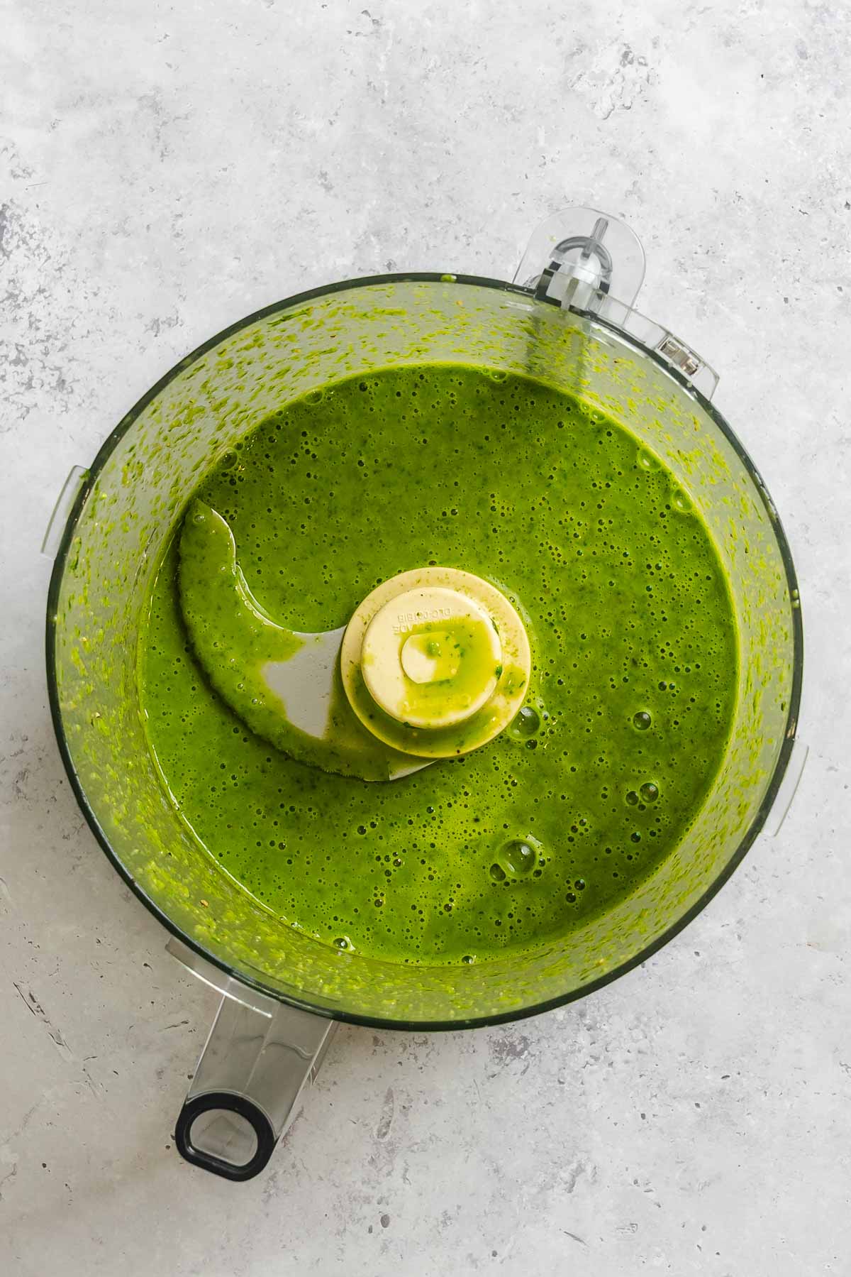 Smooth, bright green basil vinaigrette blended in a food processor.
